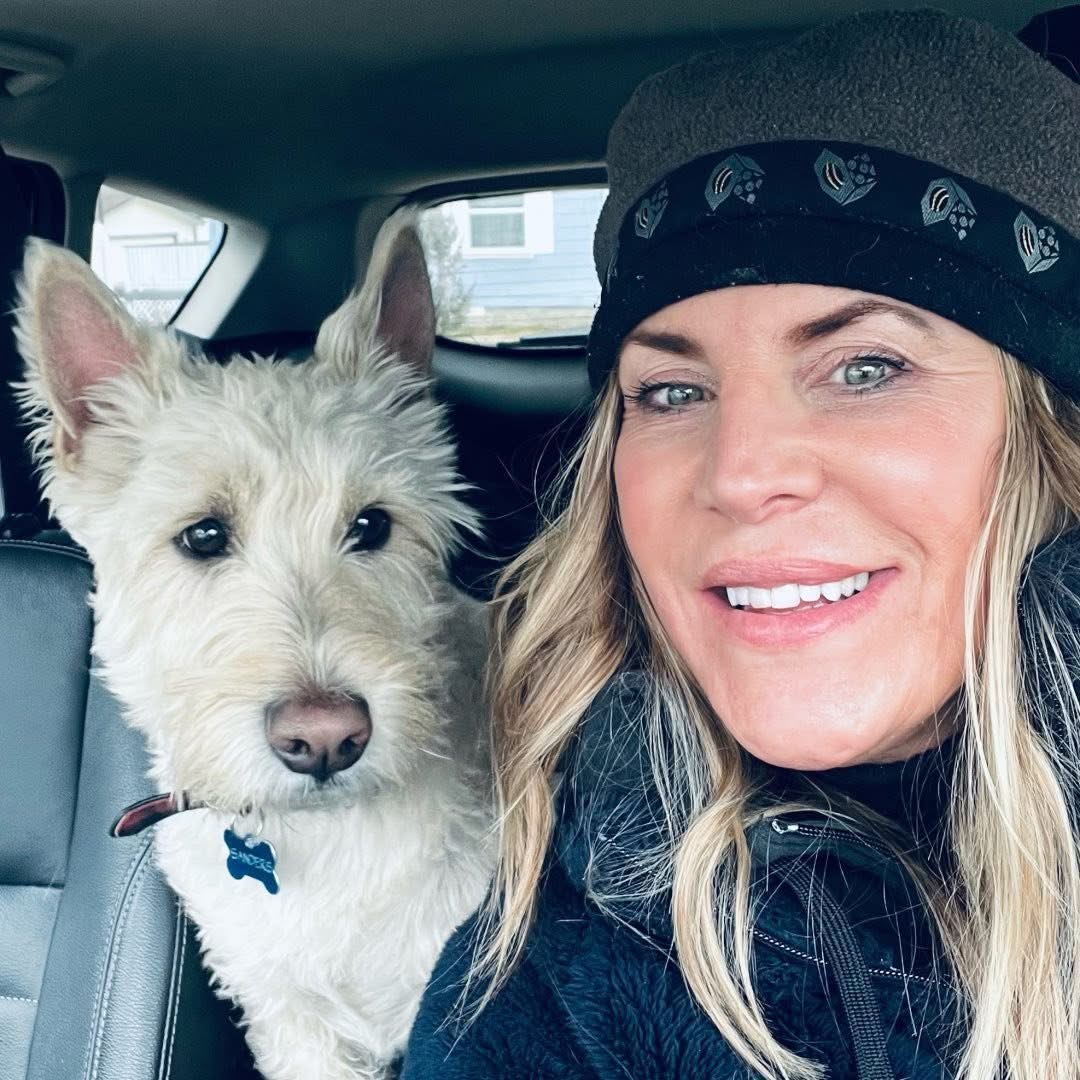 Amy and her terrier Bindle in the truck