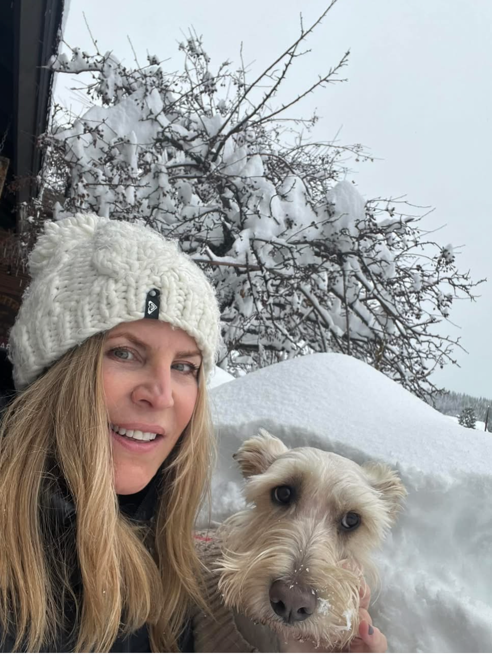Amy outside in the snow with one of her terriers